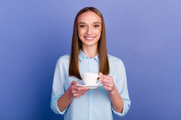 Portrait of agent girl holding in hands drinking latte isolated on blue color background
