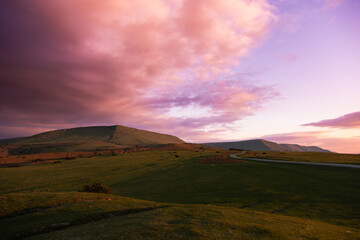 Pink sky sunset over Hay Bluff mountain peak in Brecon Beacons National Park, Wales, UK
