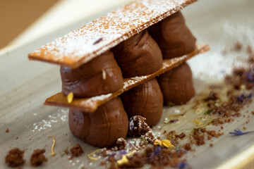 chocolate millefeuille featuring layers upon layers of flaky, caramelized puff pastry, creamy hazelnut praline, and rich Amaretto chocolate ganache is the perfect dessert for chocolate lovers 