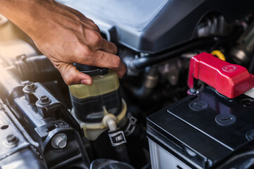 hand mechanic checking diesel fuel filter system of car