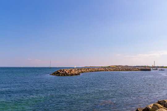  Seashore with big stones and breakwater in the distence.