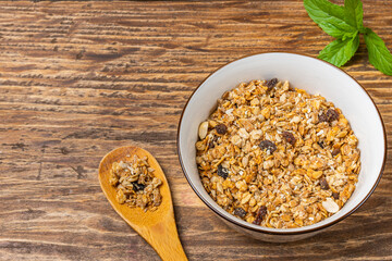 muesli in a white cup on a wooden table