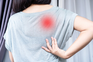 Woman suffering from Scapulocostal Syndrome Back and Shoulder Muscle Pain