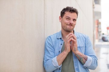 Obraz premium handsome man feeling proud, mischievous and arrogant while scheming an evil plan or thinking of a trick