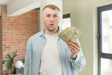 feeling extremely shocked and surprised. dollar banknotes concept