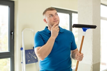 smiling with a happy, confident expression with hand on chin. windows washer