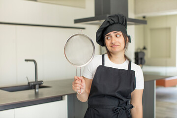 young woman smiling and looking with a happy confident expression. chef concept