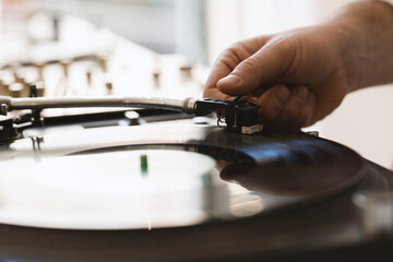 Obraz na płótnie Canvas DJ hand adjusting a needle on a vinyl record