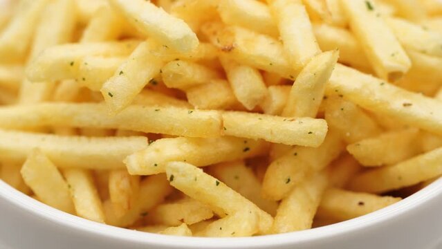 French fries background, closeup shot. Delicious potatoes with a golden fried crust. French fries background. Potato straw	