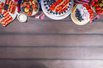 Fourth of July, Patriotic Independence day desserts.  4th of July sweet brunch food and snacks - toast sandwiches, flakes with berries, cake, pancakes, champagne with glasses, holiday decor, flags 