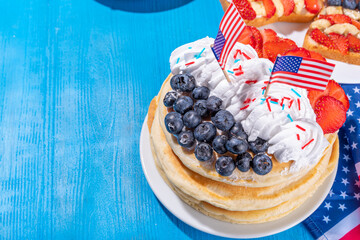 Holiday 4th of July breakfast pancakes, battercakes with whipped cream and berries like american flag. Homemade Patriotic sweet brunch or snack food, idea for party treat and desserts
