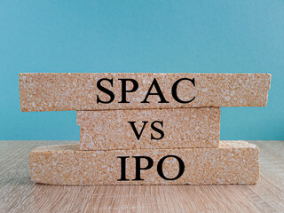 SPAC vs IPO symbol. Blocks with words 'SPAC, special purpose acquisition company' and 'IPO, initial...