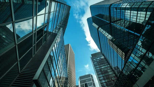 	
Low Angle View Of City Skyline Buildings, Blue Sky And Glass Mirrored Facades.	
