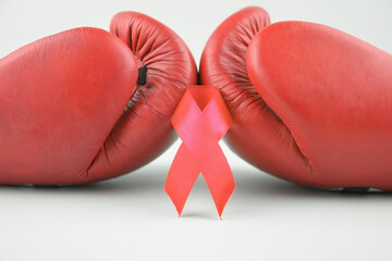 Red ribbon with boxing gloves, wrestling symbol.