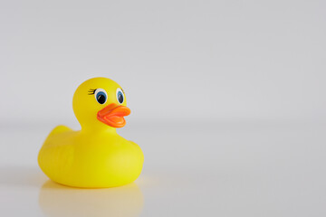 Yellow funny bath duck on white table