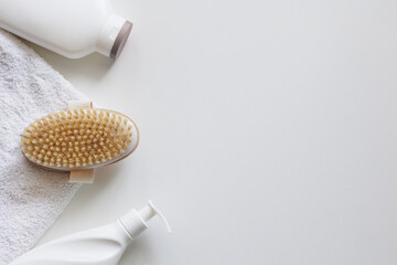 Top view of towel, cream and brush for dry massage