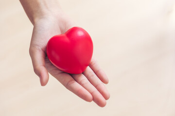 Obraz na płótnie Canvas Red heart love sign in doctor hand exercise ball with copy space for World heart health dayday, World hypertension heart attack day.