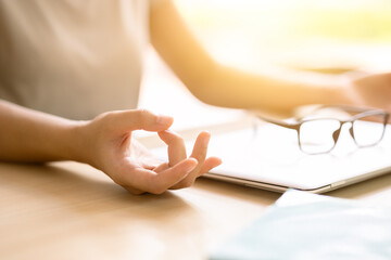 Closeup hand doing yoga concentration relax calm peace for reduce stress increase productivity at...