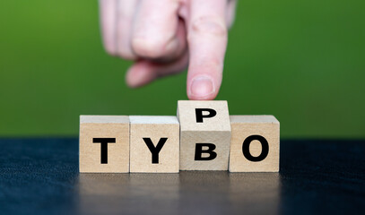 Symbol for correcting a typo. Hand turns dice and corrects the expression tybo to typo.