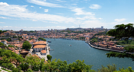 Panoramic view of the old town of Porto and the Douro river with a yacht, Portugal.