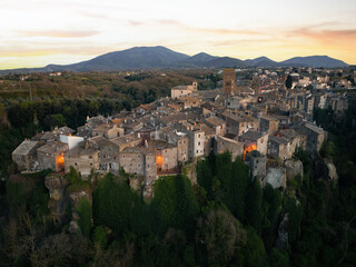 View from above, stunning aerial view of the village of Vitorchiano at sunset. Vitorchiano is a medieval Italian village in Viterbo Province, Lazio, Italy.. - obrazy, fototapety, plakaty