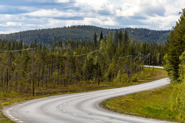 Fototapeta na wymiar Vormforsen, Sweden A typical bend in a country road through the province of Norrbotten.