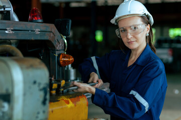 Female engineer or worker in safety clothes working in industrial factory. Industry, maintenance, production of parts in factories.
