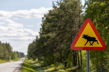 Skelleftea, Sweden A moose warning sign on a country road in summer.