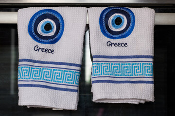 Greek evil eye embroidered on towels with the word Greece. Traditional greek symbol.