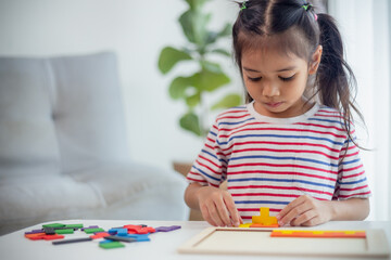 Asian girls play with puzzles, learn math, education concept