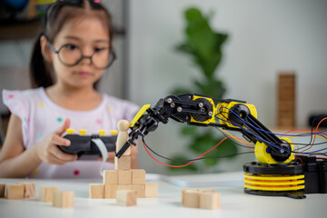 STEM education concept. Asian students learn at home by coding robot arms in STEM, mathematics engineering science technology computer code in robotics for kids' concepts