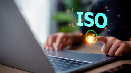 Woman presses his finger on check mark with the abbreviation ISO. ISO quality control certification concept.