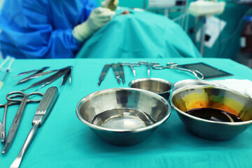 Surgical instruments, surgery, placed on a sterile green cloth, soft focus