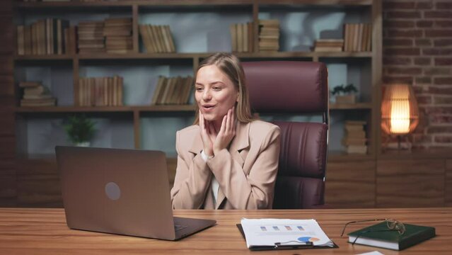 Young female entrepreneur receiving email on wireless laptop about winning profitable contract. Euphoric woman raising fists up, smiling and saying wow in excitement. Concept of success.