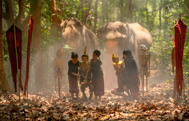 Group of Asian children show or practice manipulate the puppets in  front of big elephant in...