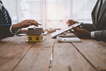 The real estate agent discusses the terms of the home purchase agreement and insurance in the...