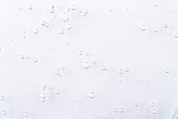 Cosmetic gel, serum transparent sample. Liquid cream with bubble texture. Gel texture of a cosmetic product. Clear liquid lotion for skin care.