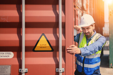 container logistic operators workers wearing yellow helmets and reflection shirts and open containers for inspection and check the condition of containers at warehouse container yard.