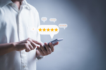 man using mobile phone with a 5-star icon on the virtual screen, showing a great experience,...