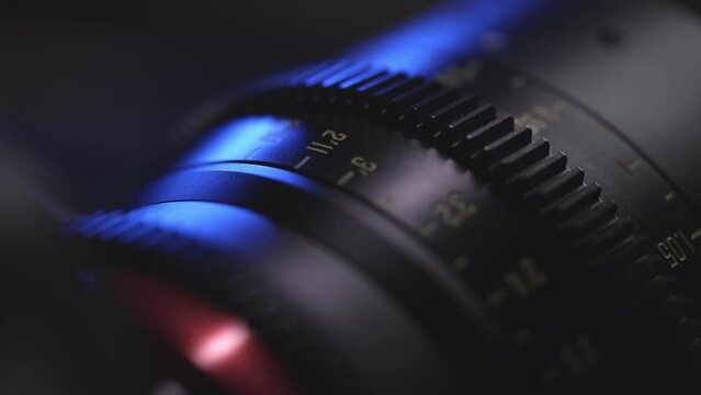 camera lens close-up of the dial with blue light in the background and blurred lens background, anamorphic lens, macro photography, video art