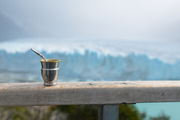 metal container for mate with bombilla on a railing near the perito moreno glacier in argentina
