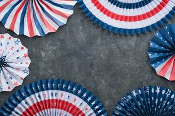 Obraz premium 4th of July background. USA paper fans, Red, blue, white stars, balloons, gold confetti on gray dark concrete background. Happy Labor, Independence or Presidents Day. American flag colors. Top view.