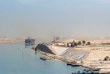 Landscape of the Suez Canal, view from the transiting cargo ship.