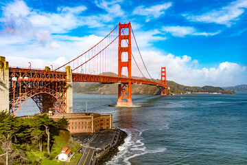 Panoramic Golden Gate of San Francisco in the state of California, USA under a beautiful blue sky and ocean. Seen from the viewpoint of the Californian city's waterfront. American bridge concept.