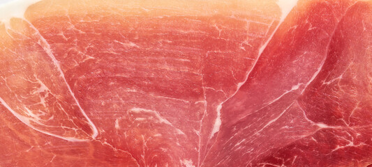 Background texture of parma ham prosciutto close up.