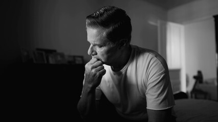 Monochrome Depiction of Middle-Aged Man Covering Face in Shame, Displaying Despair and Solitude in...