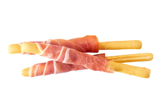italian stick bread grissini with parma ham prosciutto, traditional breadsticks with prosciutto isolated on white background  top view.