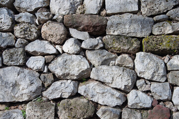 Old grey rough stone wall background