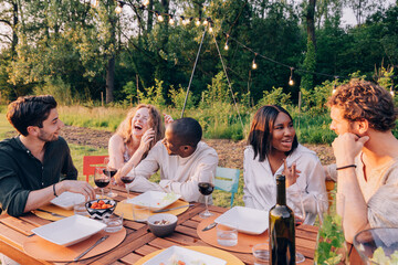 happy people enjoy together outdoor dinner