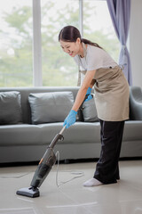 Young woman cleaning the floor in the house